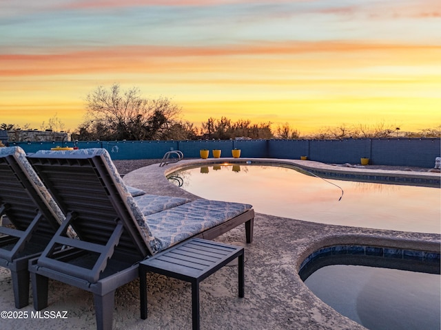 pool at dusk featuring a patio area