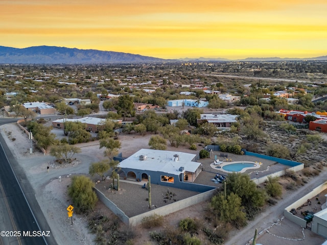 aerial view at dusk featuring a mountain view