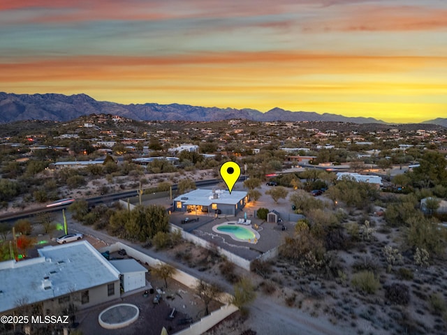 aerial view at dusk featuring a mountain view