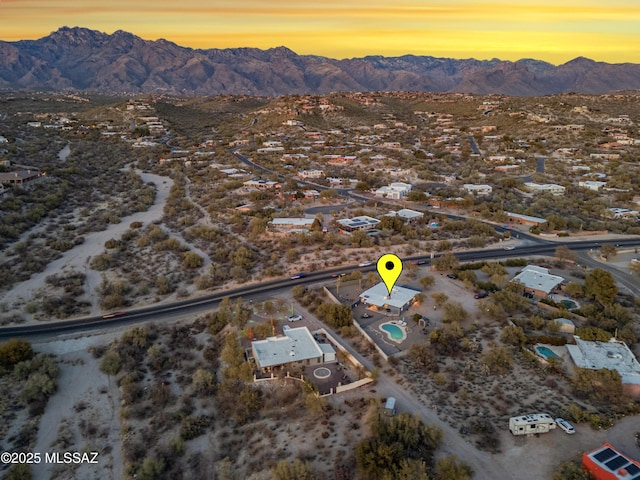 aerial view at dusk featuring a mountain view