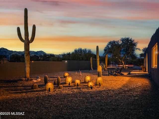 yard at dusk featuring a mountain view