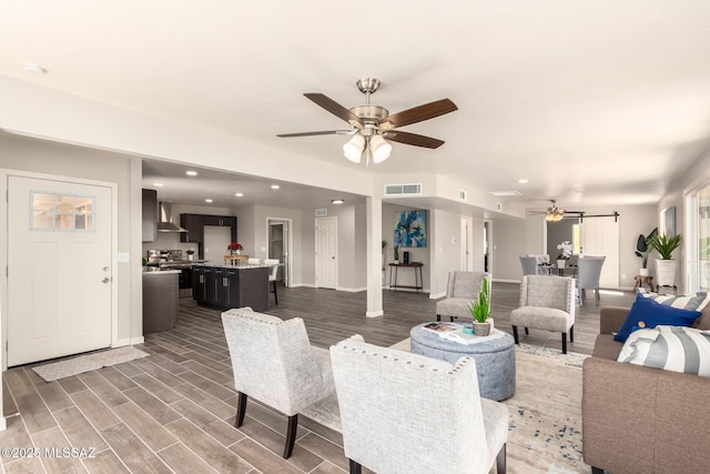 living room with dark wood-type flooring and ceiling fan