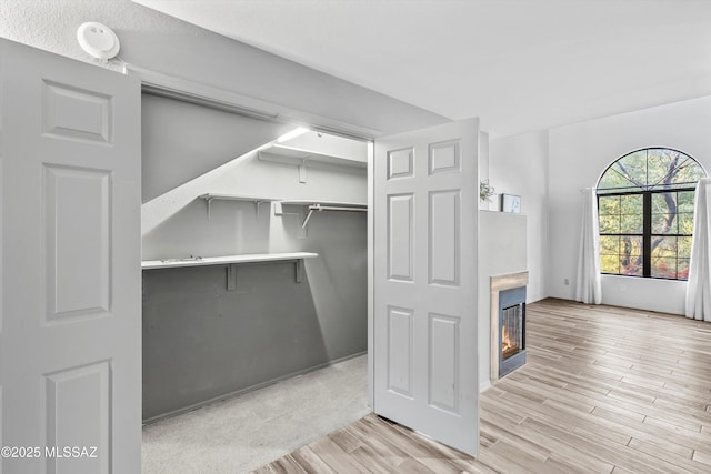 5304 N Paseo De La Terraza, Tucson, AZ 85750 - walk in closet with light wood-style floors and a glass covered fireplace