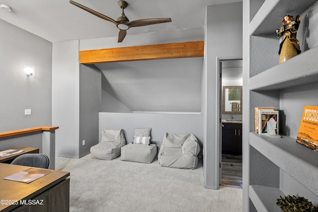 interior space with a ceiling fan, carpet flooring, and lofted ceiling with beams