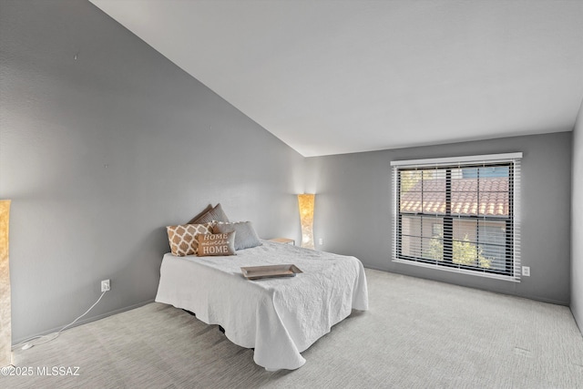 carpeted bedroom featuring vaulted ceiling