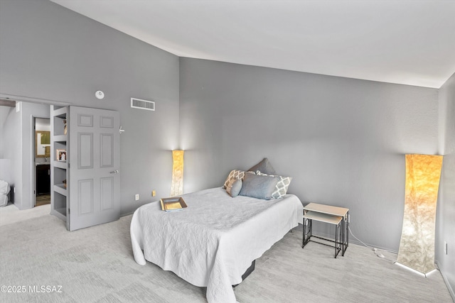 bedroom featuring light carpet and vaulted ceiling