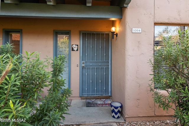 doorway to property with stucco siding