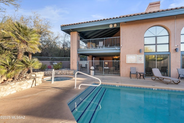 view of pool featuring a patio area and a hot tub