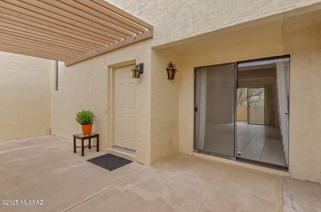 property entrance featuring a patio area