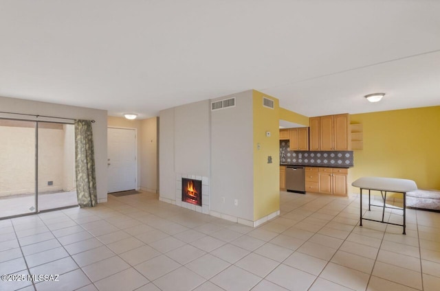 unfurnished living room with a fireplace and light tile patterned flooring