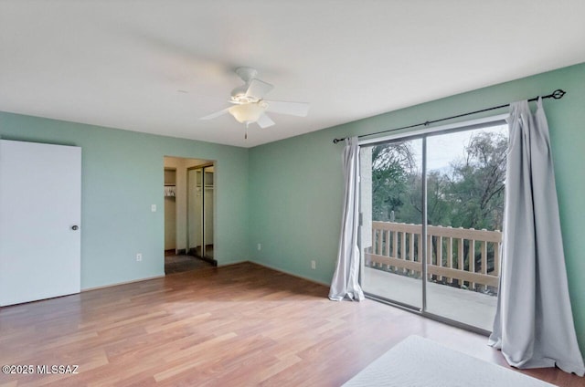 unfurnished bedroom featuring ceiling fan, light hardwood / wood-style floors, and access to outside