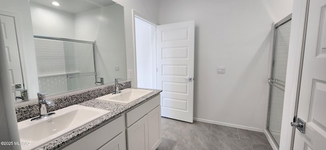 kitchen with light stone counters, stainless steel appliances, sink, a center island with sink, and white cabinetry