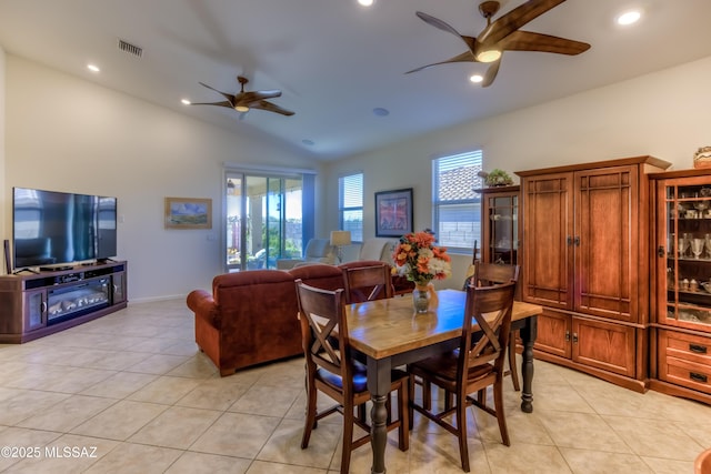 dining room with vaulted ceiling, ceiling fan, and light tile patterned flooring