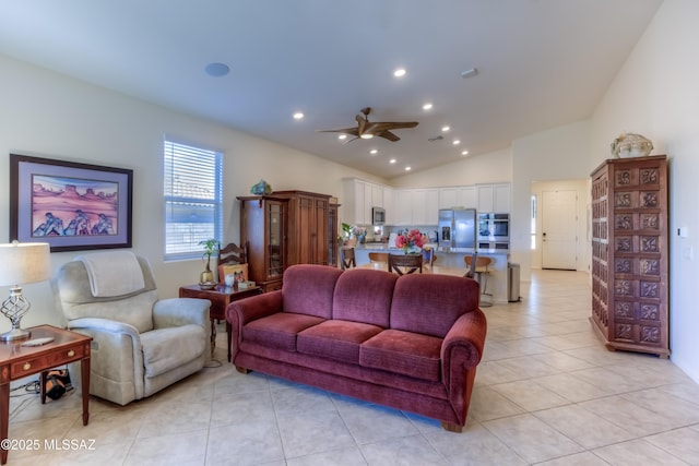 tiled living room with ceiling fan and lofted ceiling