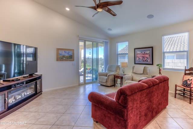 living room with ceiling fan, light tile patterned floors, and lofted ceiling