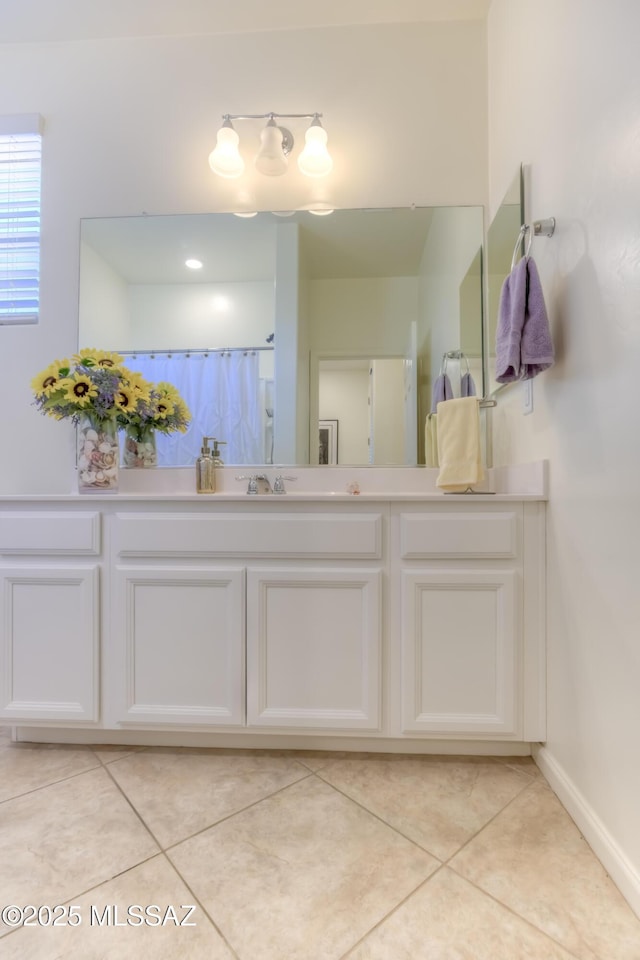 bathroom featuring vanity, tile patterned flooring, and a shower with shower curtain