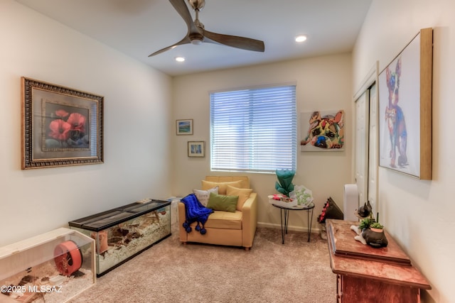 sitting room featuring ceiling fan and carpet flooring