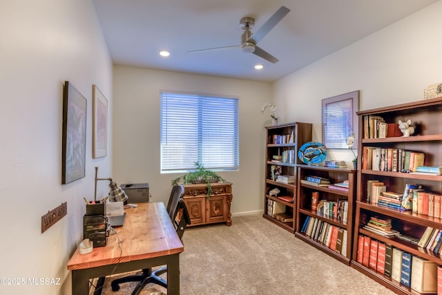 home office with ceiling fan and light colored carpet