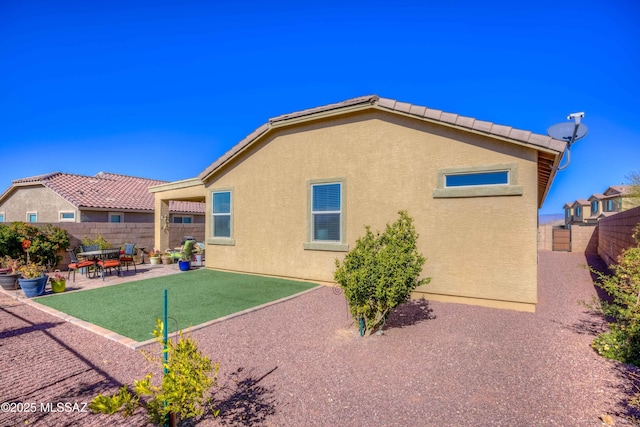 rear view of property featuring a patio area