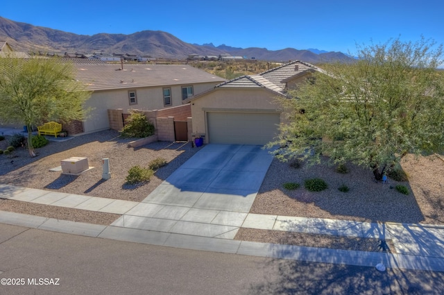 view of front of property featuring a garage and a mountain view