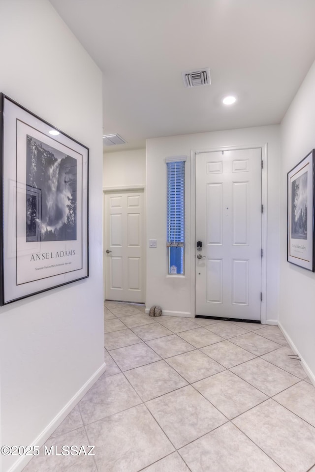 foyer entrance with light tile patterned floors