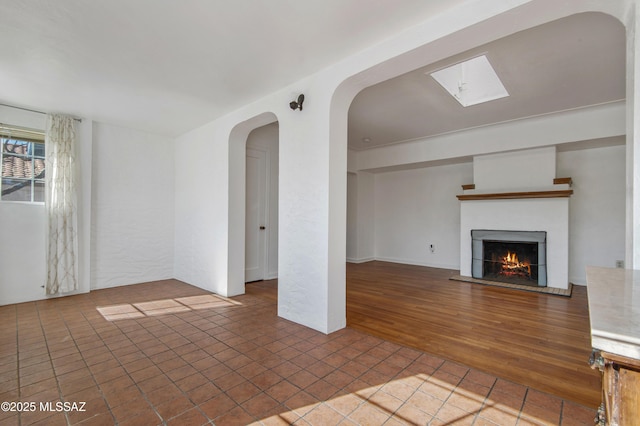 unfurnished living room featuring tile patterned flooring