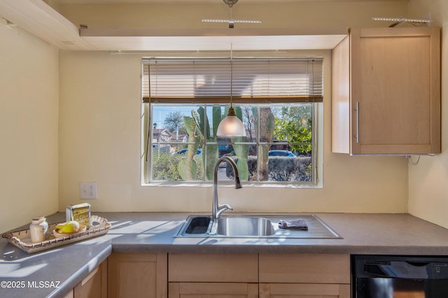 kitchen featuring light brown cabinetry, black dishwasher, and sink