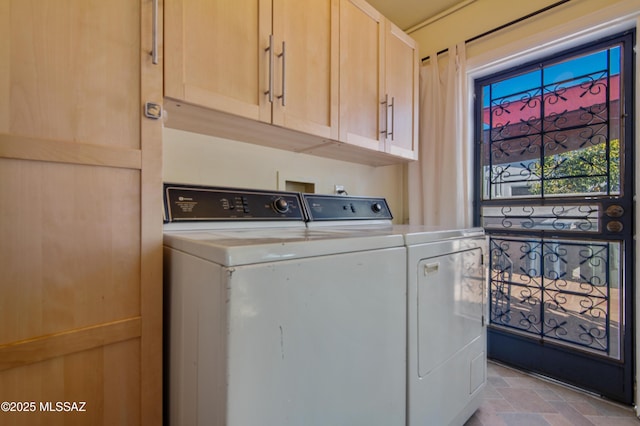 laundry room featuring cabinets and washing machine and clothes dryer