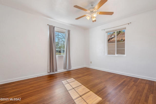 empty room featuring dark wood-type flooring and ceiling fan