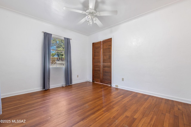 empty room with ceiling fan and wood-type flooring