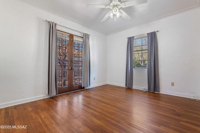 empty room with french doors, ceiling fan, and dark hardwood / wood-style floors