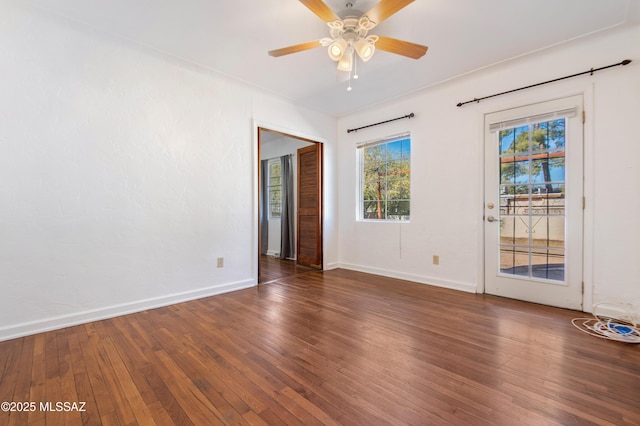 unfurnished room with dark hardwood / wood-style floors and ceiling fan