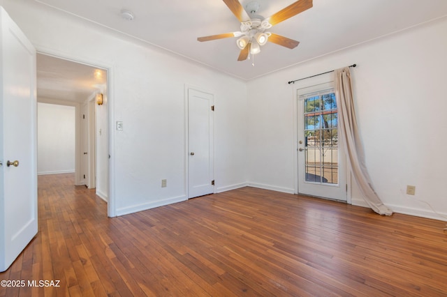 unfurnished room featuring dark hardwood / wood-style flooring and ceiling fan