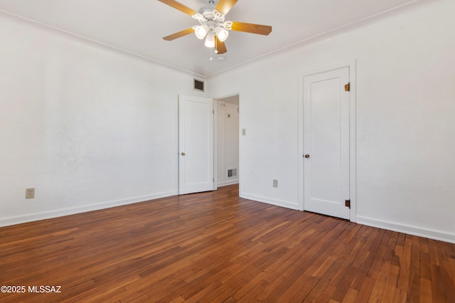 unfurnished bedroom featuring dark wood-type flooring and ceiling fan