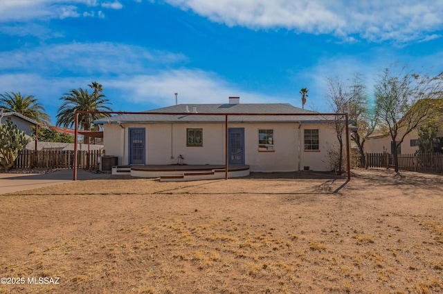 rear view of house featuring central AC