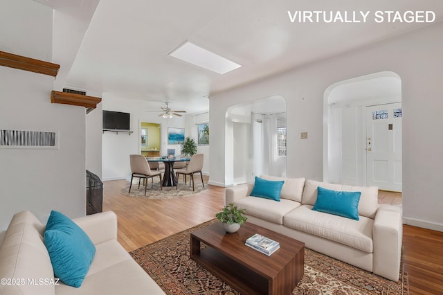 living room with ceiling fan and wood-type flooring