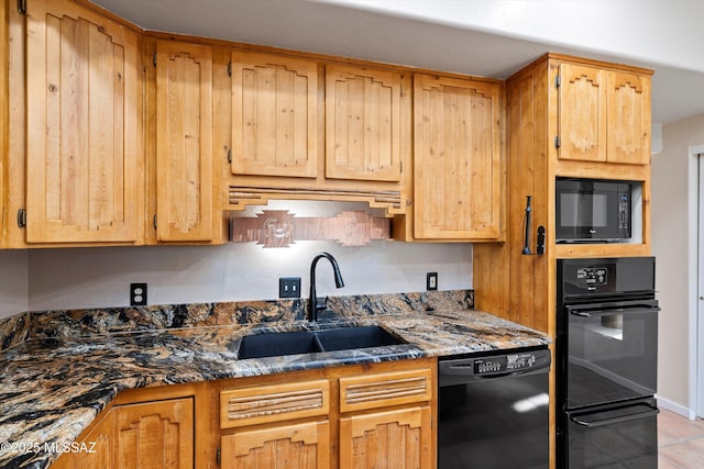 kitchen featuring black appliances, dark stone counters, and sink