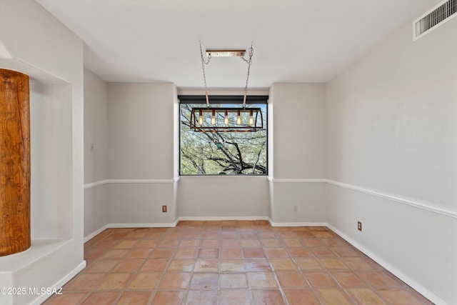 unfurnished dining area with an inviting chandelier and tile patterned floors