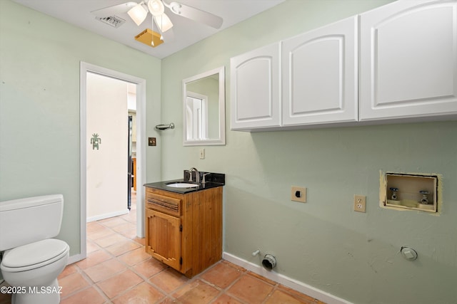 washroom with sink, hookup for an electric dryer, ceiling fan, light tile patterned floors, and gas dryer hookup