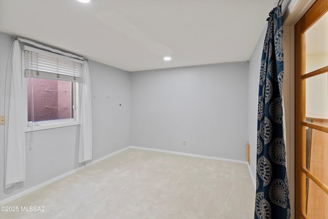 spare room with light colored carpet