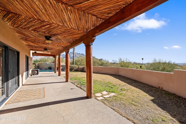 view of patio / terrace with a mountain view and a fenced in pool