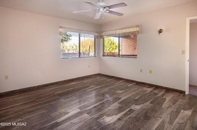 unfurnished room with dark hardwood / wood-style floors and ceiling fan