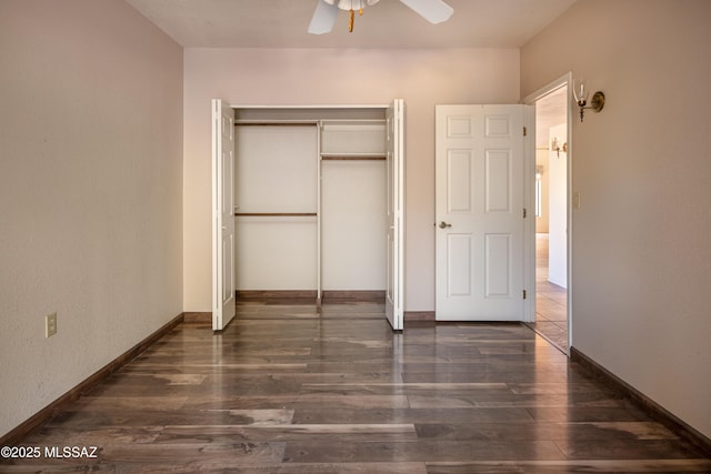 unfurnished bedroom with ceiling fan, dark hardwood / wood-style floors, and a closet