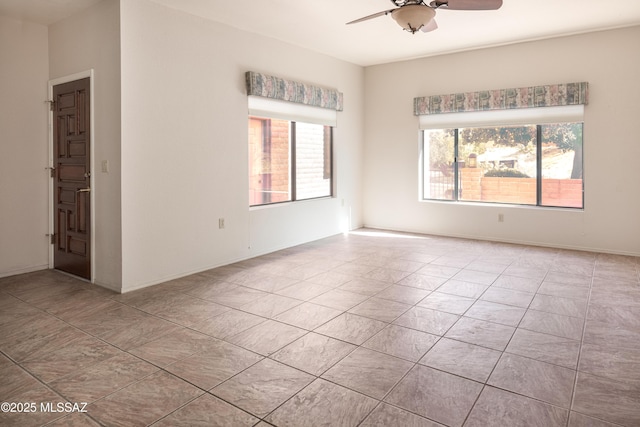 empty room featuring ceiling fan and light tile patterned flooring