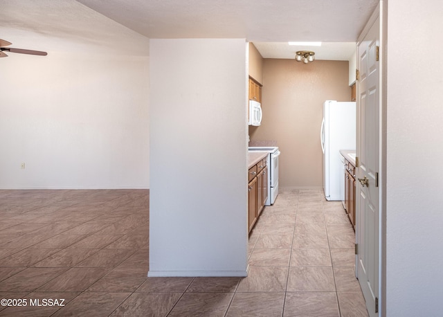 kitchen featuring ceiling fan, light tile patterned flooring, and white appliances