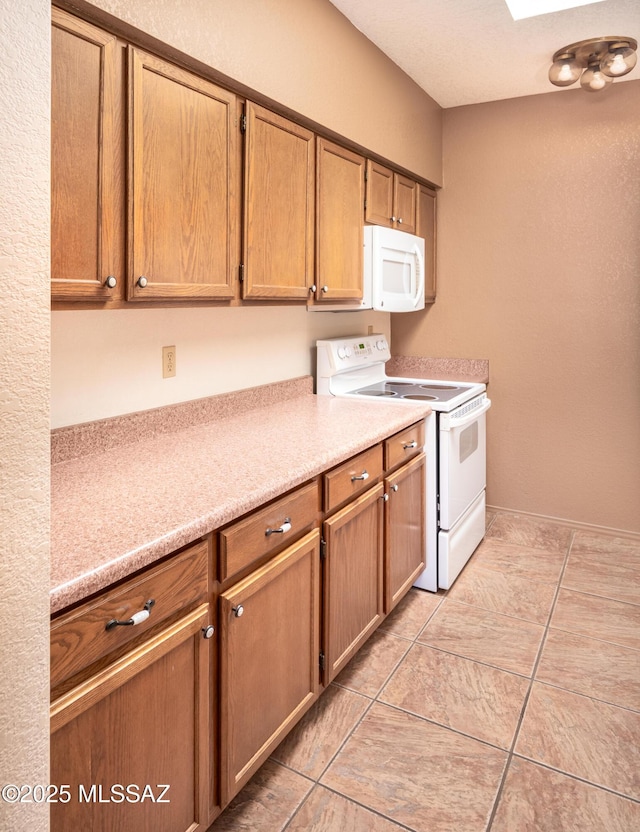 kitchen featuring white appliances and light tile patterned floors