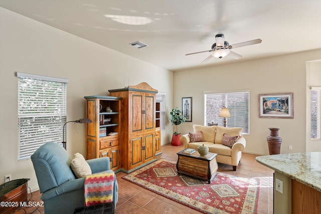 tiled living room featuring ceiling fan