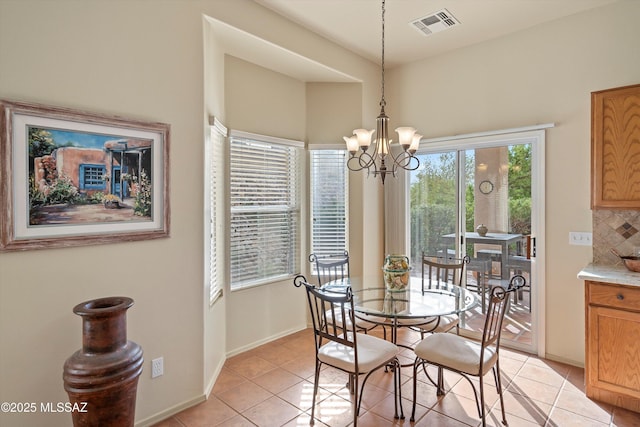 dining area featuring light tile patterned floors and a chandelier