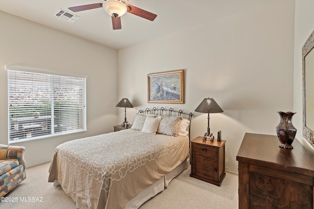 bedroom with ceiling fan and light carpet