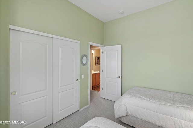 bedroom featuring light carpet and a closet